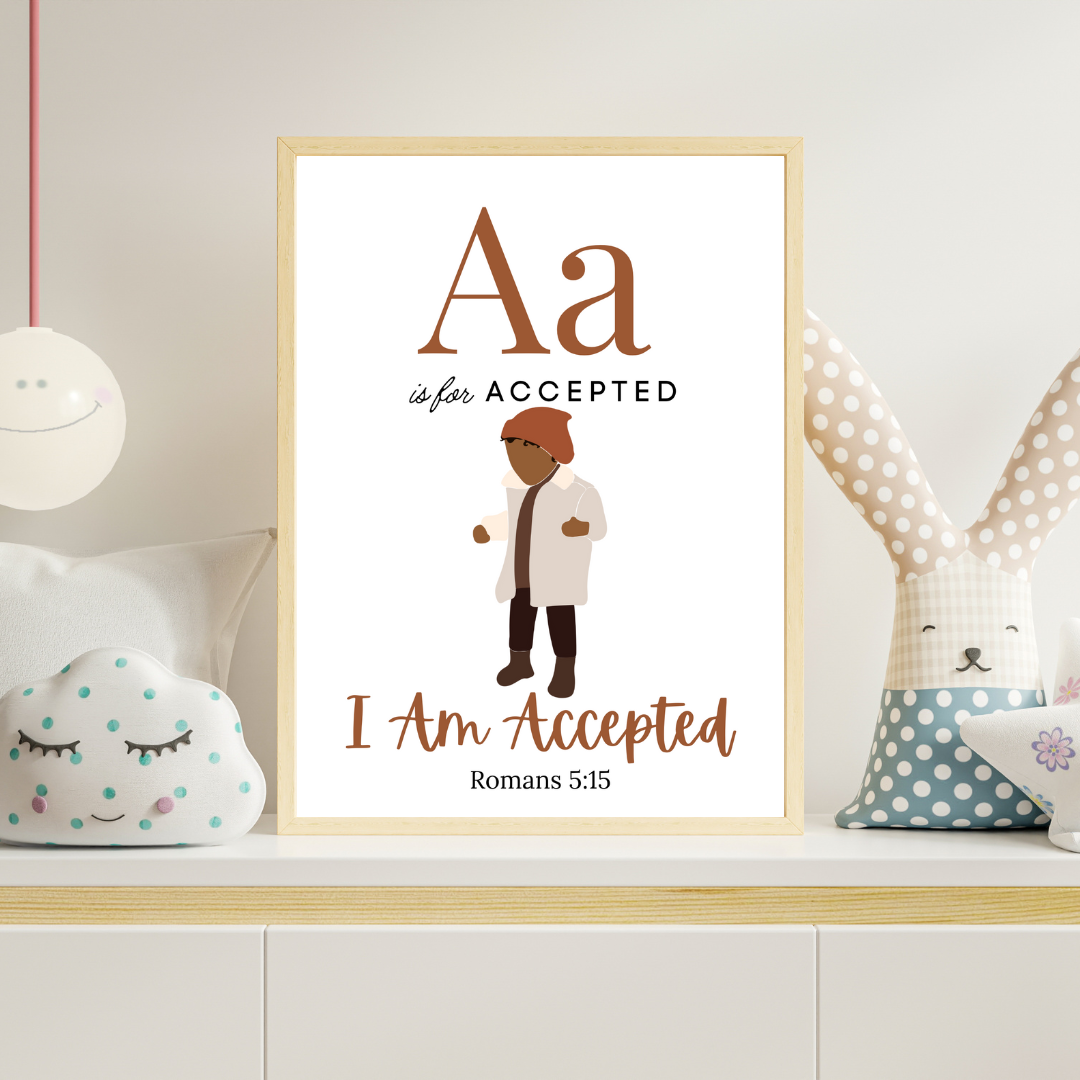 Framed artwork with text 'Aa is for Accepted, I Am Accepted Romans 5:15' on a shelf with decorative pillows.